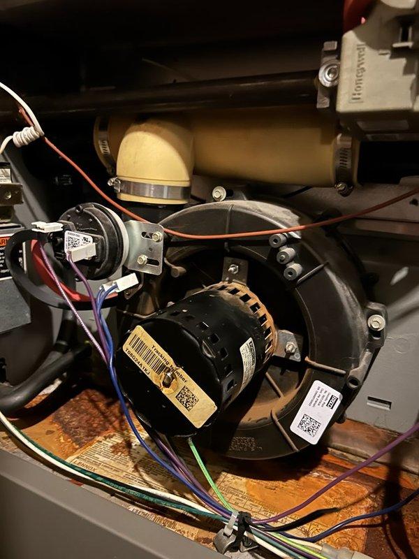 Inspected 17-year-old furnace system exhibiting intermittent shutdown issues. Diagnosed failed inducer motor assembly with significant mount deterioration allowing 1/8" lateral movement during operation. Observed extensive heat exchanger corrosion and replaced complete assembly due to safety concerns and advanced system age.