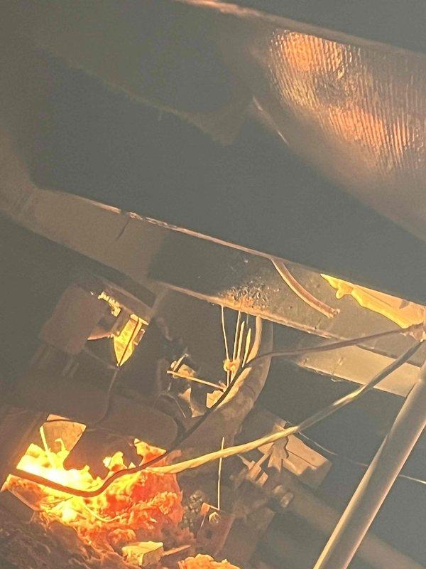 Responded to service call regarding condensate drainage issue with a 2-year-old furnace installation. Upon inspection, discovered the condensate hose had become disconnected from the drainage pipe, causing water to leak into the underbelly of the mobile home. Accessed the crawlspace, located the vinyl drainage tube, and properly rerouted it to ensure proper drainage outside the structure rather than into the underbelly.