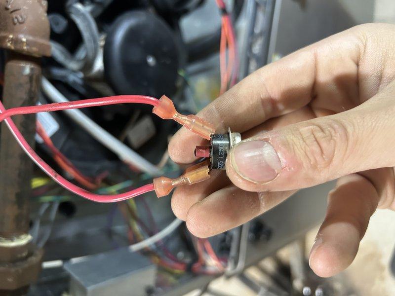 Responded to no heat call for aging furnace (10+ years). Diagnosed failed rollout switch which was stuck in open position. Performed temporary bypass to verify proper system operation. Inspection revealed early-stage cracking in collector box and significant rust accumulation on burners. Client declined immediate repairs; service advisor scheduled for follow-up consultation.