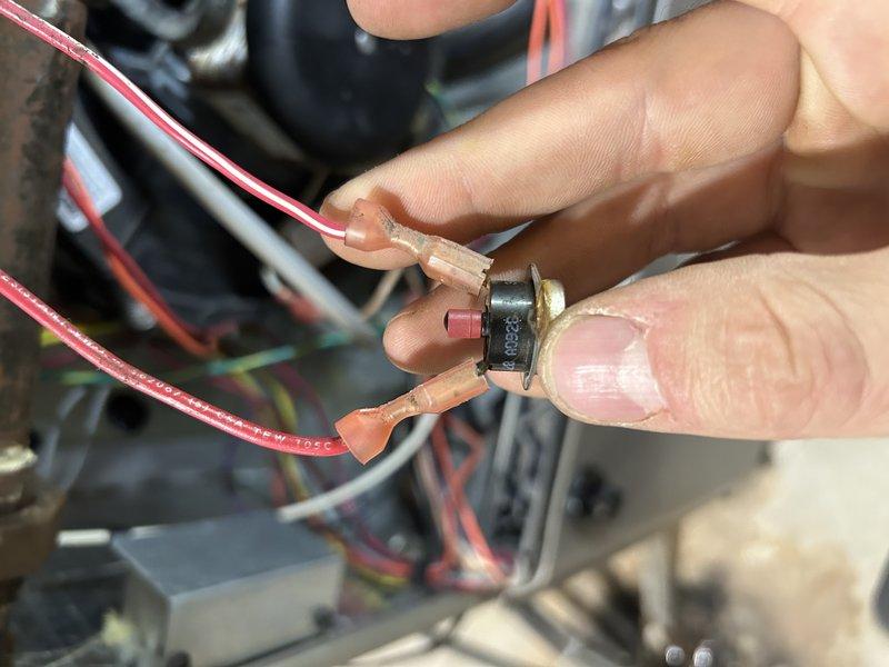 Responded to no heat call for aging furnace (10+ years). Diagnosed failed rollout switch which was stuck in open position. Performed temporary bypass to verify proper system operation. Inspection revealed early-stage cracking in collector box and significant rust accumulation on burners. Client declined immediate repairs; service advisor scheduled for follow-up consultation.