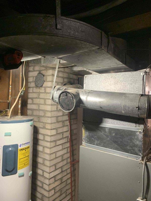 Responded to service callback for oil furnace with ignition and heating failure. Diagnosed system lockout caused by excessive soot accumulation in exhaust flue, as evidenced by visual inspection and documented soot removal. Successfully restored proper operation after purging fuel line, inspecting nozzle and ignition components, clearing error codes, and confirming multiple successful system startups with normal combustion.