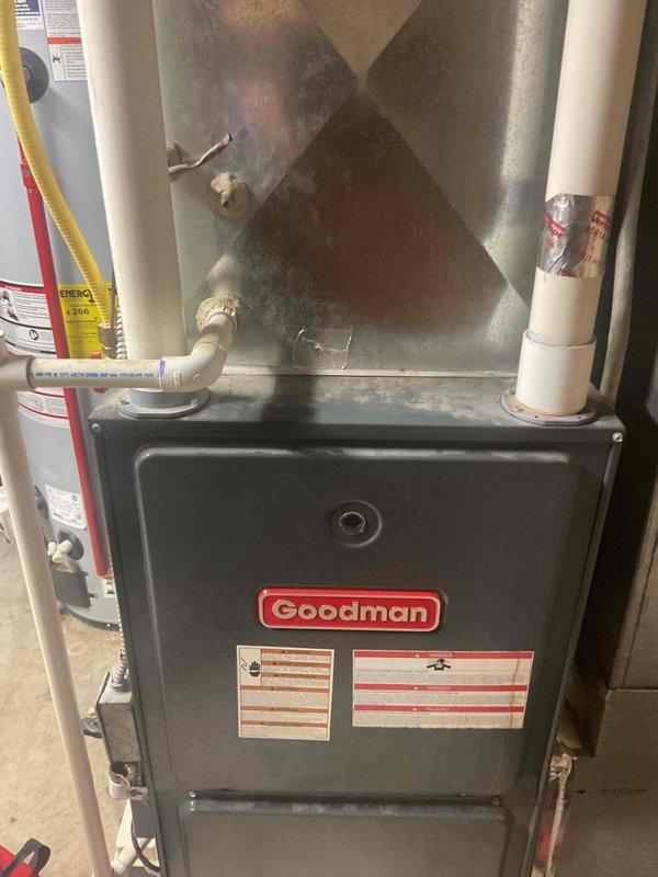 Responded to no-heat call on aging Goodman furnace that was previously serviced for a leak. Diagnosed issue with sticking door switch that was preventing proper operation. Restored normal functionality by adjusting the door switch mechanism. Performed combustion analysis with Testo 310 II, confirming system is now operating within acceptable parameters (CO: 21ppm, efficiency: 67.2%).