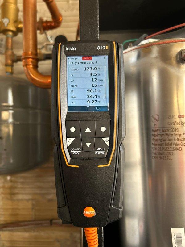 Completed annual furnace maintenance on 3-year-old system with Rewards membership. Performed combustion analysis with Testo 310 II analyzer showing 90.1% efficiency, normal CO/CO2 levels, and proper excess air (24.4%). Verified proper operation of IBC unit with associated plumbing and venting system; all components functioning correctly with no operational issues identified.