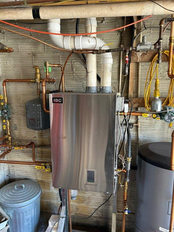 Completed annual furnace maintenance on 3-year-old system with Rewards membership. Performed combustion analysis with Testo 310 II analyzer showing 90.1% efficiency, normal CO/CO2 levels, and proper excess air (24.4%). Verified proper operation of IBC unit with associated plumbing and venting system; all components functioning correctly with no operational issues identified.