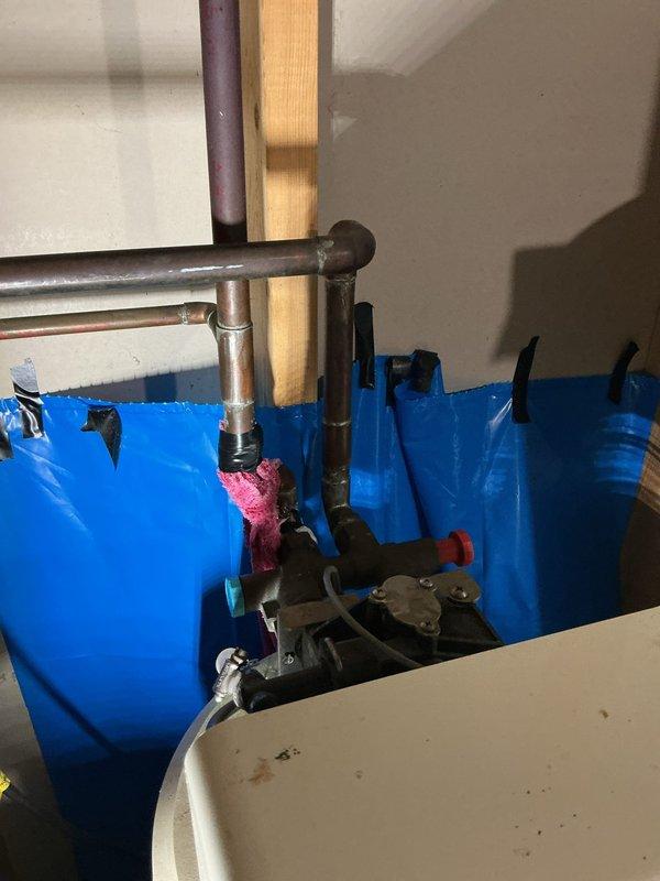 Responded to emergency service call for a pin hole leak on a copper elbow fitting connected to customer's water softener in the basement. Successfully repaired the compromised joint and also completed installation of a new kitchen faucet as requested. Utilized protective tarping during repair to prevent water damage to surrounding areas.