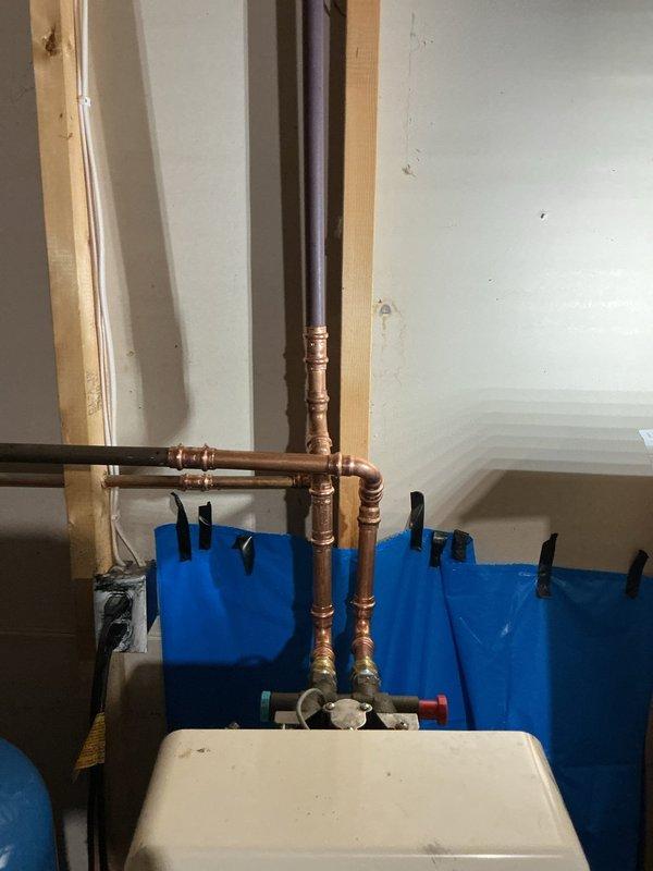 Responded to emergency service call for a pin hole leak on a copper elbow fitting connected to customer's water softener in the basement. Successfully repaired the compromised joint and also completed installation of a new kitchen faucet as requested. Utilized protective tarping during repair to prevent water damage to surrounding areas.