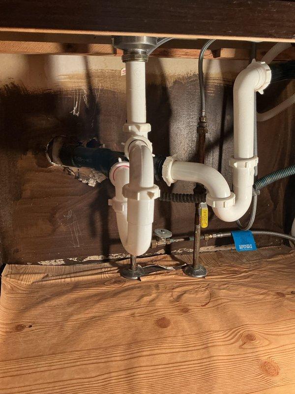 Responded to customer call reporting a leak under kitchen sink. Upon inspection, discovered a broken p-trap causing drainage issues. Completed full drain rebuild, including replacement of the damaged PVC p-trap assembly and reconnection of all drainage components to ensure proper function and eliminate the leak.
