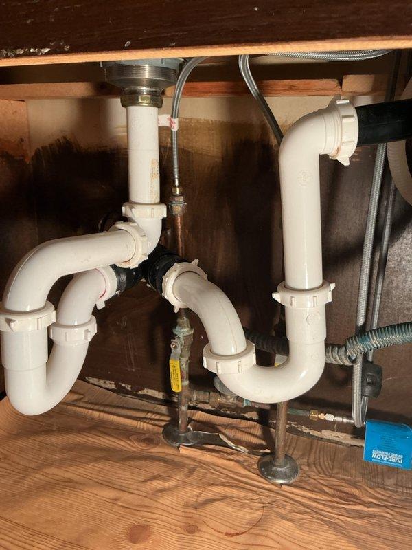 Responded to customer call reporting a leak under kitchen sink. Upon inspection, discovered a broken p-trap causing drainage issues. Completed full drain rebuild, including replacement of the damaged PVC p-trap assembly and reconnection of all drainage components to ensure proper function and eliminate the leak.