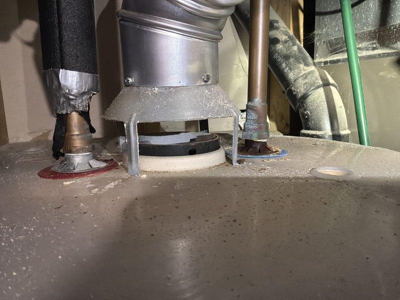 Responded to service call for water leak on 20+ year old 60-gallon natural gas water heater. Diagnostic inspection revealed tank rupture causing water to spray from the side of the unit. Pressure gauge reading showed approximately 20-30 PSI. Customer opted for complete system replacement with tankless water heater, scheduled for future installation.