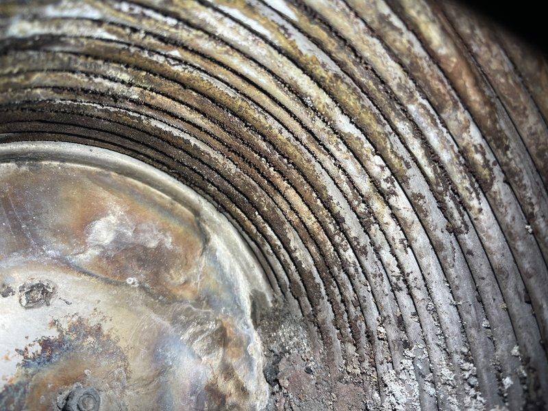 Responded to service call for non-operational Munchkin boiler in warehouse. Upon inspection, discovered pinhole leak in heat exchanger rendering the unit non-serviceable. Client will contact for replacement estimates as this is a secondary heat source. Additionally, restored proper pressure to main building boiler by adding water.