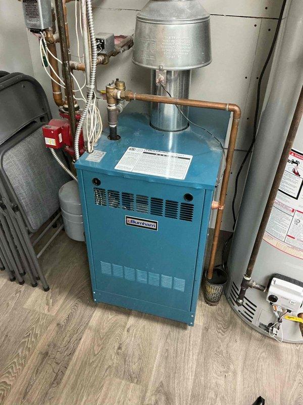 Performed annual maintenance on 14-year-old Burnham natural gas boiler with hydronic radiant heating system. Inspection revealed good condition of piping, expansion tank, heat exchanger, pressure relief valve, and backflow prevention. Identified one zone valve motor that opens but fails to make its end switch for boiler activation. Combustion analysis showed safe operation with minor heat exchanger seal deterioration (1 ppm leakage) requiring future monitoring.