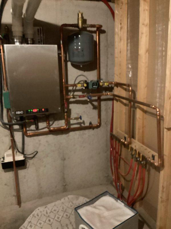 Responded to a service call regarding low/no water pressure affecting one side of the home. Investigated the system and found sediment accumulation (sand) in faucets and toilets causing pressure restrictions. Performed cleaning of affected fixtures and inspected the water heater and boiler system to verify proper operation after service.