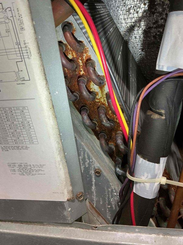 Completed furnace maintenance on 21-year-old Magic Pack unit. Inspected system for safety and reliability, finding properly functioning blower motor with clean wheel and strong flame sensor, ignitor, and draft motor. Noted capacitor below specification and detected severe rust with potential pinholes in heat exchanger visible through burner inspection. Scheduled service advisor to discuss replacement options due to heat exchanger integrity concerns.