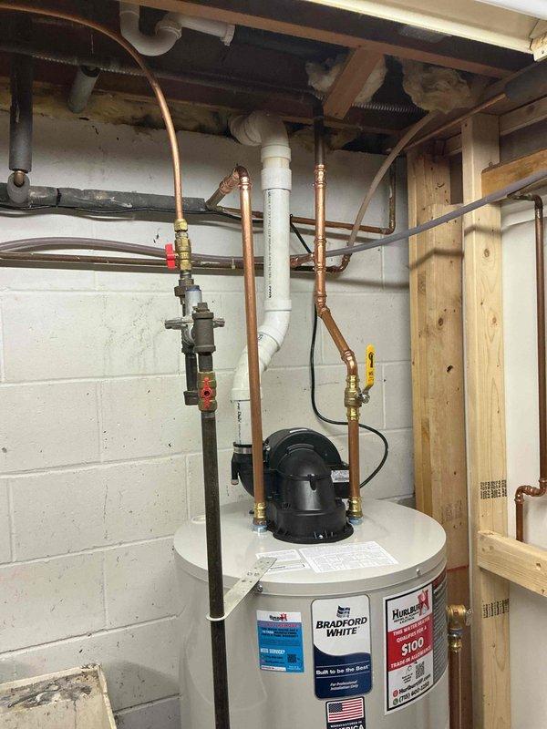 Responded to service call for 6-7 year old natural gas power vent water heater that was repeatedly shutting down despite customer attempts at troubleshooting. Upon inspection, determined water heater was non-functional beyond repair. Successfully removed failed unit and installed new 50-gallon Bradford White power vent natural gas water heater with proper connections to existing copper supply lines and PVC venting.