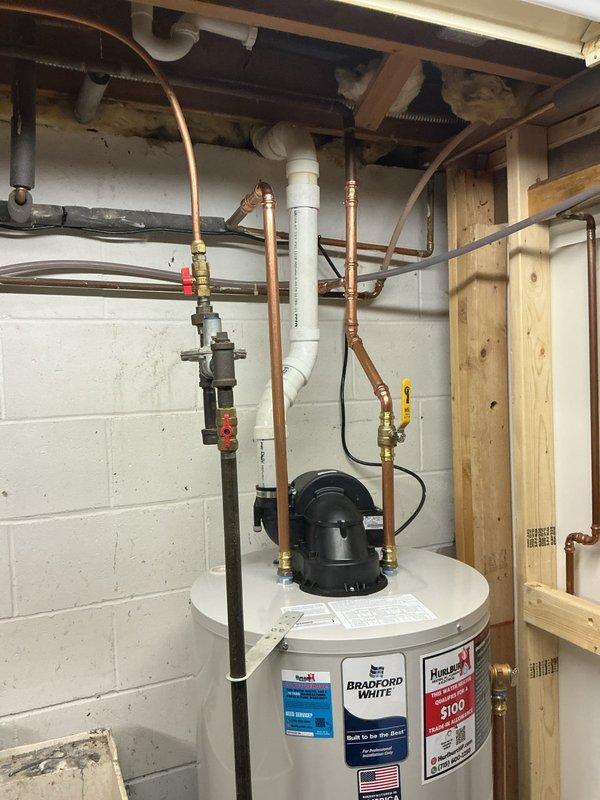 Responded to service call for 6-7 year old natural gas power vent water heater that was repeatedly shutting down despite customer attempts at troubleshooting. Upon inspection, determined water heater was non-functional beyond repair. Successfully removed failed unit and installed new 50-gallon Bradford White power vent natural gas water heater with proper connections to existing copper supply lines and PVC venting.