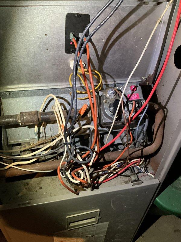 Performed routine maintenance tune-up on a 33-year-old Goodman furnace. Inspection revealed blower motor leaking oil and heat exchanger showing signs of wear. Recommended comfort advisor consultation for evaluation of aging system components.