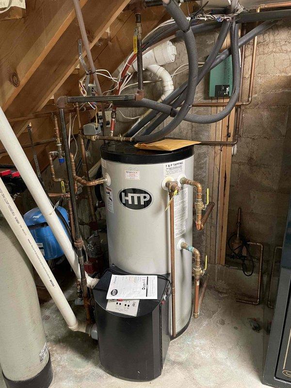 Responded to no heat/no hot water complaint on 13-year-old Phoenix HTP system. Diagnosed loud grinding noise from inducer motor. Upon inspection of the ECM variable speed inducer, discovered 120V winding was open with OL reading between hot and neutral. Inducer failed completely after inspection, resulting in total system shutdown. Recommended replacement of failed inducer motor and discussed options for system upgrade to combi unit or boiler with indirect tank.