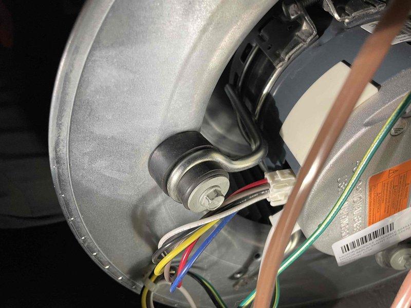 Performed warranty service to replace missing bolt for blower mount assembly. Installed carrier bolt for motor bracket, securing the blower assembly to housing. Verified proper operation after installation; unit functioning correctly with no additional components required.