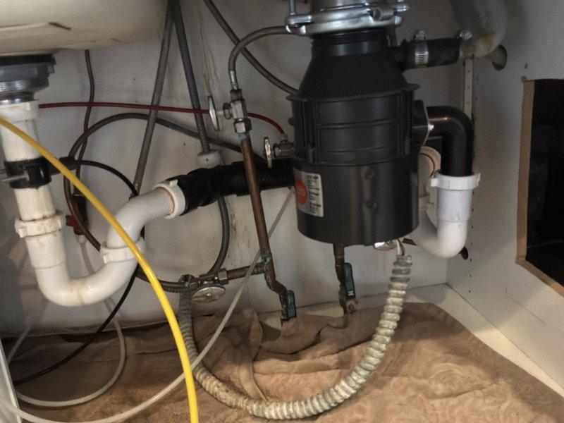 Inspected customer-supplied faucet installation project and provided options for replacing two faucets with new stops. Evaluated existing plumbing configuration including garbage disposal connection and P-trap assemblies. Customer will consider the proposed options before scheduling the installation work.