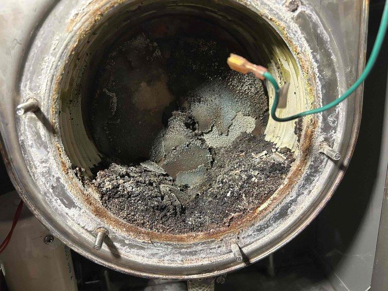 Performed scheduled boiler tune-up service, cleaning drain system and ignition assembly components. Inspection revealed severely deteriorated burner refractories with significant corrosion and sediment buildup in the combustion chamber. Customer will be provided with replacement options and pricing.