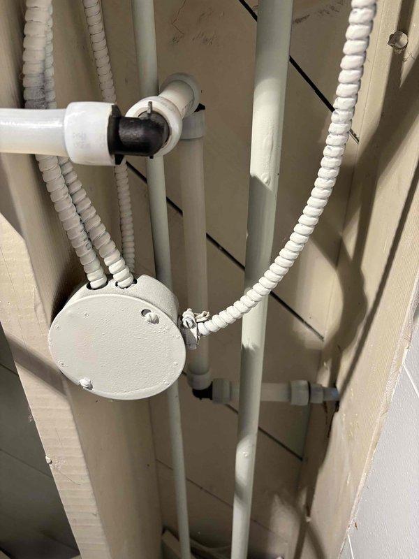 Replaced deteriorated outdoor hose bib and remediated leaking copper piping in the plumbing system that was causing water intrusion between floors. Cut out damaged copper section, installed new piping connections, and secured a loose toilet with silicone sealant to prevent further leakage issues.