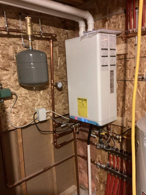Responded to service call for non-operational boiler serving in-floor heating system. Diagnosed issue with year-old unit that was installed by another contractor. Determined boiler was left in standby mode rather than operation mode. Adjusted controller settings to proper operation mode, which resolved the issue completely. System now functioning correctly with all components operating as designed. Installation workmanship appears satisfactory.