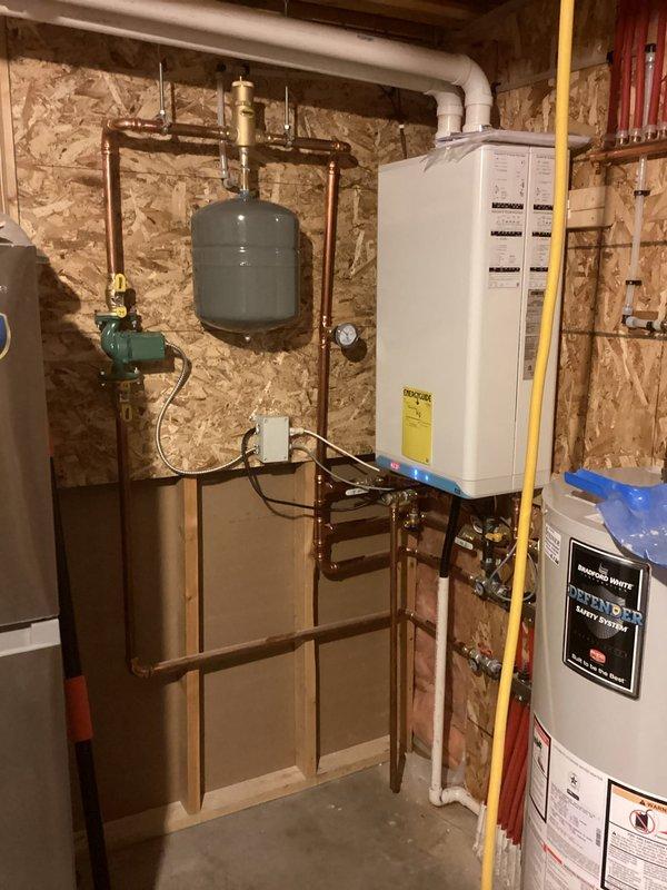 Responded to service call for non-operational boiler serving in-floor heating system. Diagnosed issue with year-old unit that was installed by another contractor. Determined boiler was left in standby mode rather than operation mode. Adjusted controller settings to proper operation mode, which resolved the issue completely. System now functioning correctly with all components operating as designed. Installation workmanship appears satisfactory.