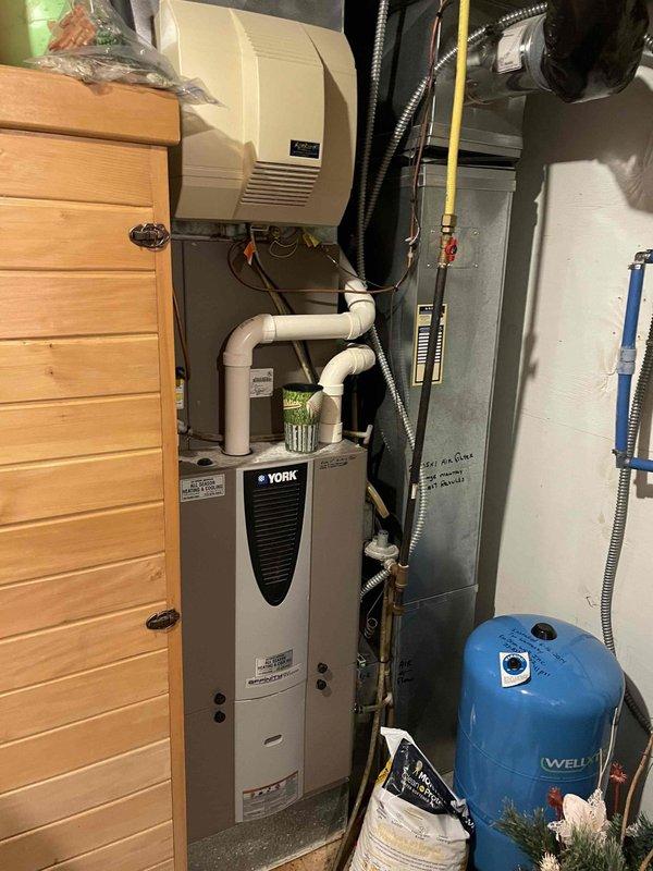 Diagnosed Munchkin in-floor heating system displaying F14 error code with recurring fan pressure faults. Examination revealed plugged heat exchanger and deformed spark rod causing intermittent ignition. Cleared clogged AC condensate line and temporarily adjusted spark rod. Recommended heat exchanger cleaning service and replacement of both spark rod and flame sensor components to resolve the issue and restore proper system operation.
