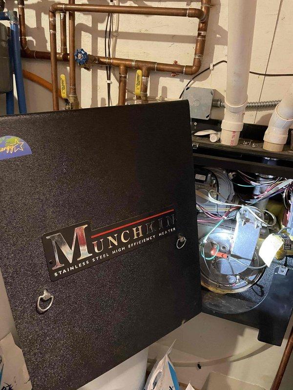 Diagnosed Munchkin in-floor heating system displaying F14 error code with recurring fan pressure faults. Examination revealed plugged heat exchanger and deformed spark rod causing intermittent ignition. Cleared clogged AC condensate line and temporarily adjusted spark rod. Recommended heat exchanger cleaning service and replacement of both spark rod and flame sensor components to resolve the issue and restore proper system operation.