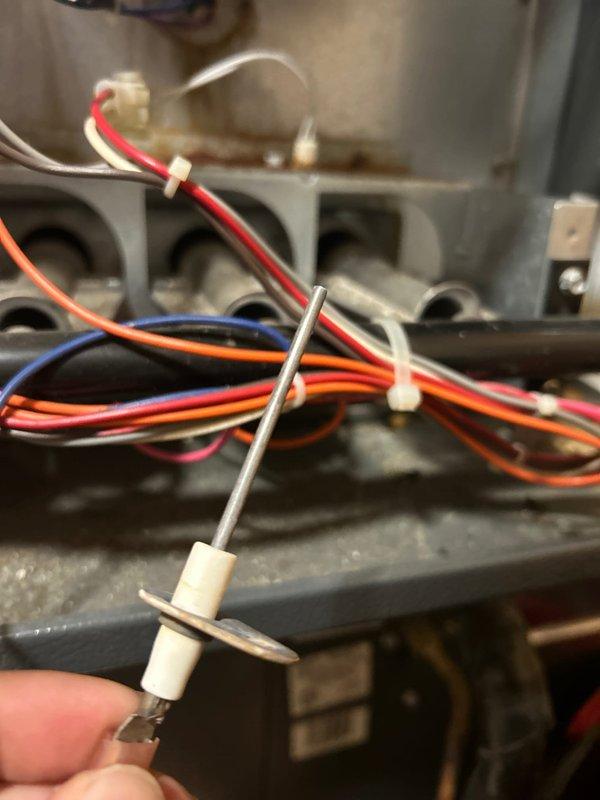 Completed routine maintenance on a 15-year-old Goodman natural gas furnace. Verified system is burning safely with good electrical components and connections. Cleaned flame sensor and noted rusting on ignitor which could cause future issues, though currently operational. All amp draws within normal range and condensation drains clear.