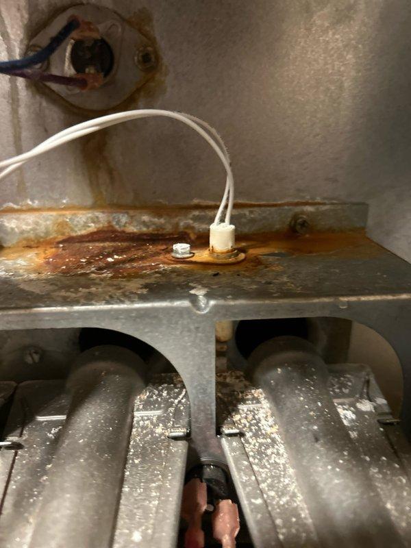 Completed routine maintenance on a 15-year-old Goodman natural gas furnace. Verified system is burning safely with good electrical components and connections. Cleaned flame sensor and noted rusting on ignitor which could cause future issues, though currently operational. All amp draws within normal range and condensation drains clear.