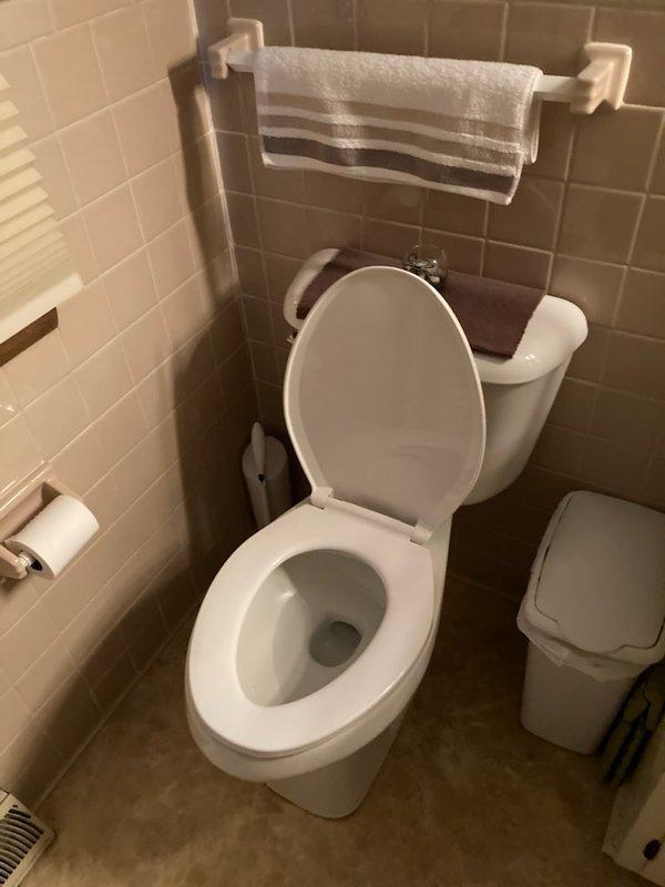 Responded to service call regarding toilet leaking at base. Upon inspection, found crack in toilet base around rim causing the leak. Removed damaged toilet and installed new ADA-compliant tall elongated toilet with proper wax seal and bolts. Tested for proper flushing operation and confirmed no leaks at base after installation.