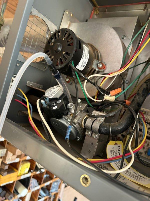 Diagnosed garage heater with no-heat condition and found stuck gas valve and high gas pressure setting. Restored temporary operation by manually freeing valve and calibrating gas pressure to correct specifications. Recommended gas valve replacement to prevent recurrence of the issue.