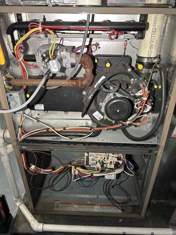 Performed comprehensive HVAC tune-up on 5-year-old furnace reported to have previously failed a combustion safety test. Inspection revealed extremely corroded and rusty burners contributing to high CO readings. Thoroughly examined heat exchanger (showing some rust but no cracks or holes), verified normal gas pressure, and confirmed proper operation of inducer and blower motors. Cleaned condensation trap and inspected flue pipe with no issues found. Replaced deteriorated burners to resolve the combustion safety concern and ensure proper system operation for the heating season.