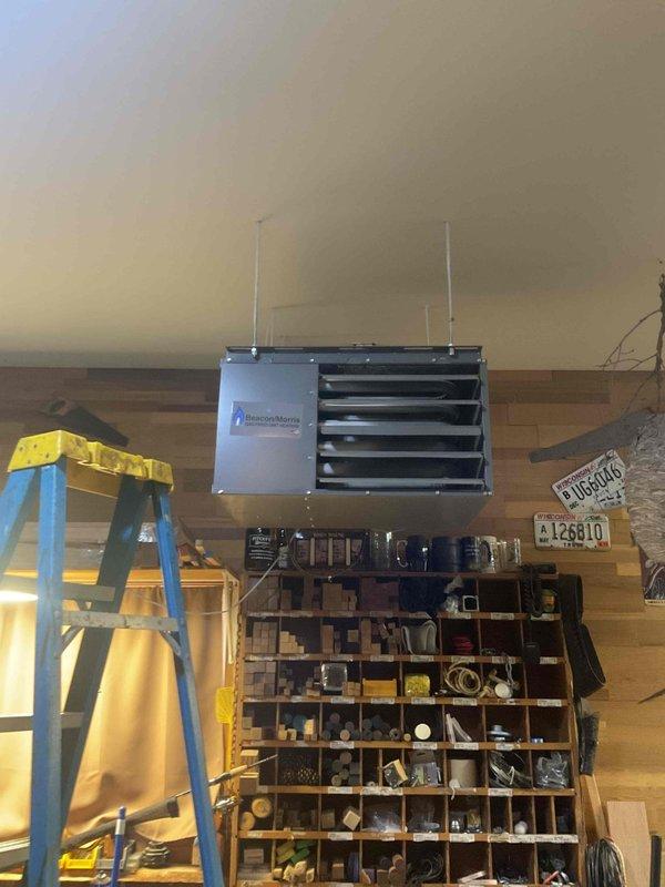 Diagnosed garage ceiling-mounted heating unit that was cycling on briefly then shutting down. Determined gas valve was malfunctioning - valve would initially open but then fail during operation. Replaced faulty gas valve to restore proper heating function.