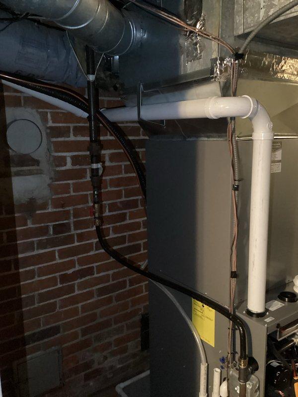 Diagnosed intermittent flame failure on recently installed Verna furnace due to pressure fluctuations in exhaust system. Identified major low spot in exhaust piping causing water accumulation, which created vacuum irregularities from the inducer motor and resulted in gas valve cycling between stages. Return visit required to re-pipe exhaust line to eliminate low spot and restore proper operation.