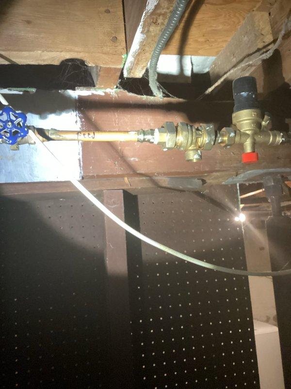 Replaced leaking water heater, relocated unit from corner position, and modified boiler loop piping to facilitate removal of old unit. Observed boiler was non-operational throughout service; scheduled follow-up visit with technician to diagnose and resolve boiler functionality issues. Documented installation with photos of plumbing infrastructure and valve assemblies for record-keeping.