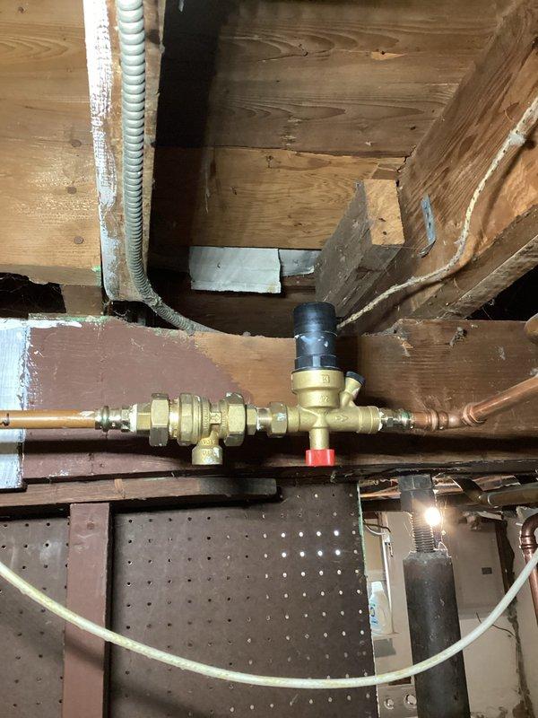 Diagnosed low pressure issue in aging boiler system causing intermittent heating failure. Discovered malfunctioning backflow preventer preventing proper operation of the auto fill valve. Manually cleared the stuck backflow preventer to restore water flow, properly pressurized the system, and restored heat to the residence. Documented need for replacement of both backflow preventer and auto fill valve as recommended repair.