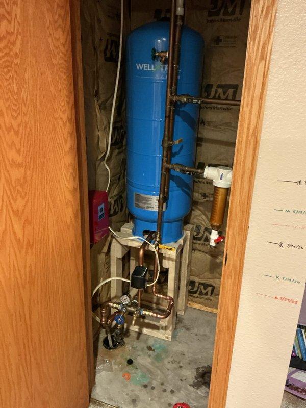 Successfully replaced waterlogged 32-gallon well pressure tank and tee assembly to restore proper system functionality. Installation included removal of failed components, fitting of new pressure tank, and reconnection of existing copper supply lines. This repair prevents potential pump motor burnout by maintaining proper water pressure and flow throughout the system.