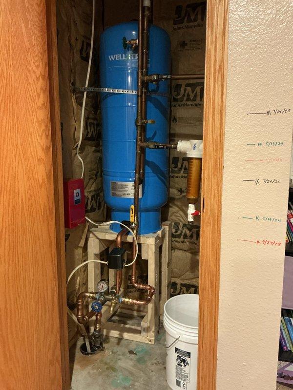 Successfully replaced waterlogged 32-gallon well pressure tank and tee assembly to restore proper system functionality. Installation included removal of failed components, fitting of new pressure tank, and reconnection of existing copper supply lines. This repair prevents potential pump motor burnout by maintaining proper water pressure and flow throughout the system.
