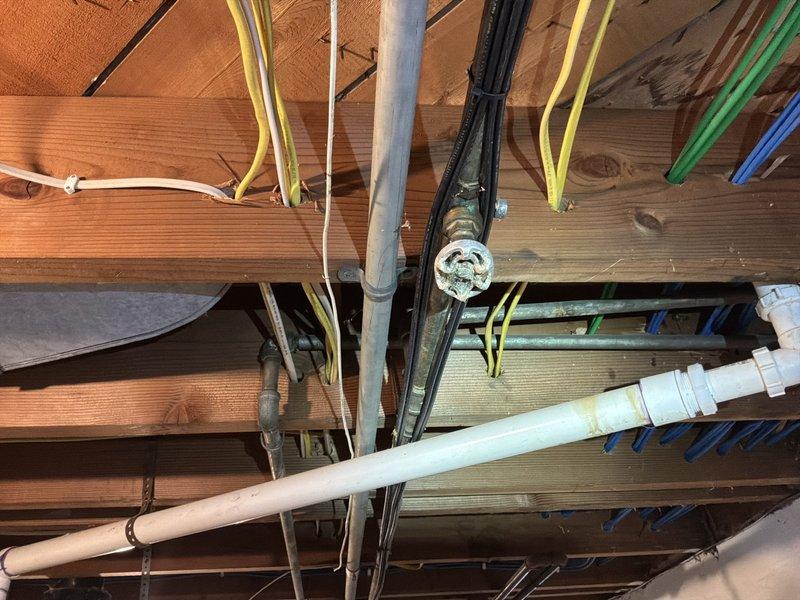 Paperwork processed to update customer's estimate after decision to replace broken customer-supplied water softener with our recommended unit. No on-site service performed at this time. Photos document existing plumbing infrastructure and water heater installation for reference.