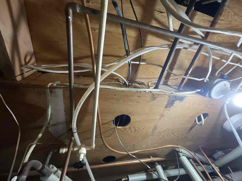 Responded to water softener leak issue from system piping. Upon inspection, identified leak in the copper pipe section near the water treatment equipment. Repaired compromised pipe connection at the filter/separator marked "OUTSIDE" and verified proper operation of the blue cylindrical tank and associated control panel. System now functioning without leaks.