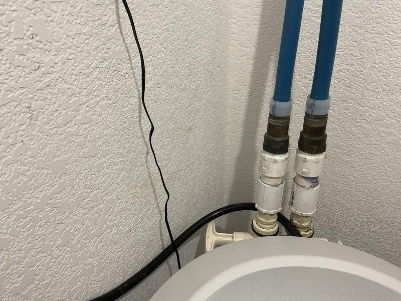 Responded to service call for water softener leak. Discovered leak at bypass valve on main floor softener unit. Removed the leaking water softener and looped the existing 3/4" PEX lines together to maintain system functionality. Note: property was originally a duplex with dual softener systems; second softener remains in place and operational.