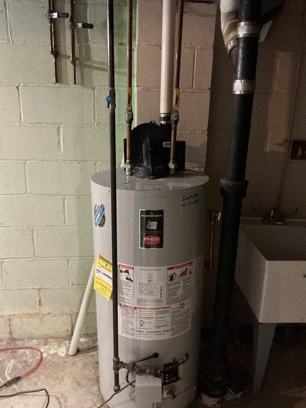 Installed a 50-gallon natural gas power vent water heater, replacing existing unit of similar type. Additionally, secured loose dishwasher with screws to prevent movement and restored hot water pressure to main level bathroom sink by fully opening a partially closed valve located in the ceiling.