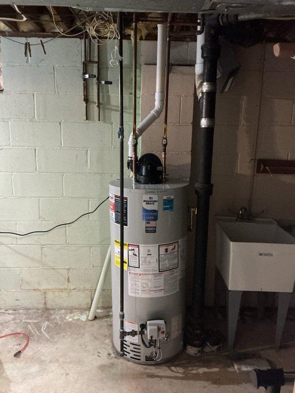 Installed a 50-gallon natural gas power vent water heater, replacing existing unit of similar type. Additionally, secured loose dishwasher with screws to prevent movement and restored hot water pressure to main level bathroom sink by fully opening a partially closed valve located in the ceiling.