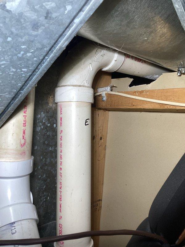 Responded to no heat complaint on recently installed unit. Diagnosed low pressure lockout due to pressure switch failure (error code 255). Determined water accumulation in exhaust venting crossing over finished ceiling and under four seasons room is preventing proper operation of second stage heating. Temporary repairs unsuccessful; recommended return visit with additional assistance to access and re-pitch exhaust pipe requiring removal of plywood sheeting from floor outside the four seasons room.