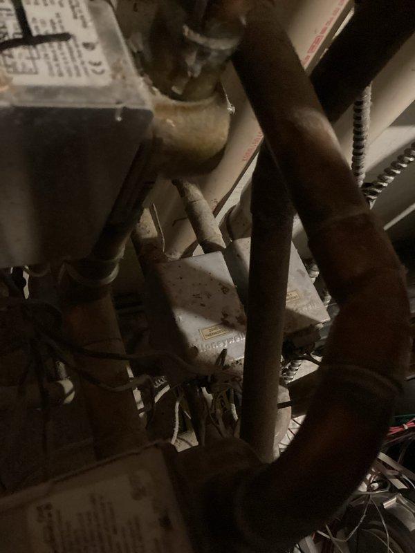 Responded to no-heat complaint on a 20-year-old Munchkin boiler system following customer's attempted Nest thermostat installation which caused electrical shorting. Diagnostic testing revealed transformer failure preventing voltage delivery to zone valves. System wiring was found to be disorganized with an aftermarket control board installation. Additionally drained boiler system at customer's request to facilitate upcoming pipe modifications.