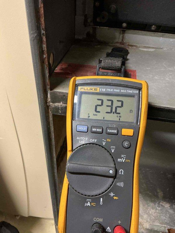 Performed routine inspection and maintenance on 21-year-old furnace as part of bi-annual service agreement. Testing revealed several aging components including weakening igniter, deteriorating flame sensor, and draft motor exhibiting chirping noise indicating imminent bearing failure. Observed early-stage heat exchanger deterioration with formation of pinholes, though no complete penetration detected that would require immediate decommissioning. Electrical diagnostics confirmed component resistance values were within operational parameters. Discussed replacement options with homeowners.
