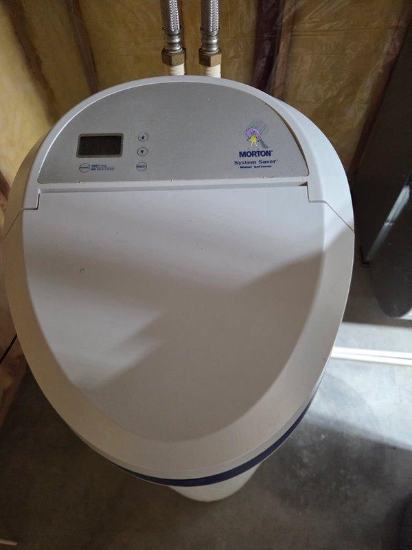 Inspected Morton System Saver water softener that was not using salt due to salt bridge formation. Broke up salt bridge, cleaned brine tank, and performed system reset. Unit now functioning properly with normal salt consumption resumed.