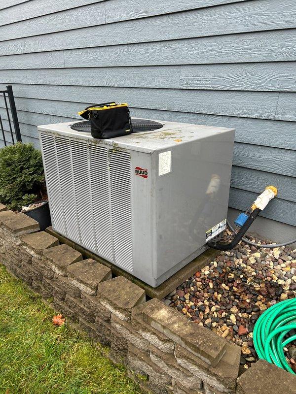 Responded to service call for a Ruud heat pump system exhibiting irregular operation. Diagnostics revealed high amperage draw on compressor, pressure drop, and refrigerant deficiency. System assessment showed proper airflow and clean coils, but compressor was making rough sounds with frequent cycling and unusual startup noise. Customer reported clanking sounds near furnace during system shutdown. Advised customer of repair options; customer elected to operate on emergency heat mode pending final decision on system repair.